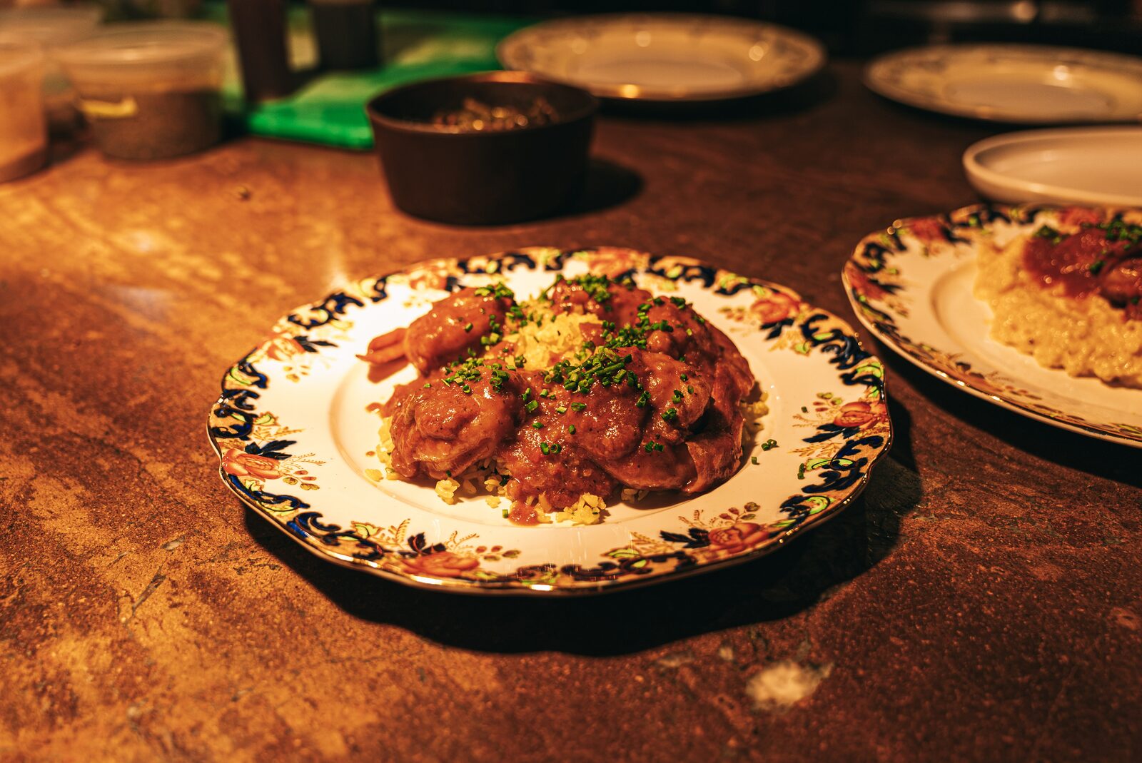 Shrimp creole over grits on vintage china - Creole restaurant Walnut Creek